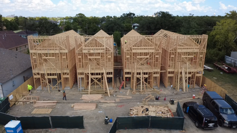 Aerial view of Cross Builds townhomes under wood framing construction in Houston, TX
